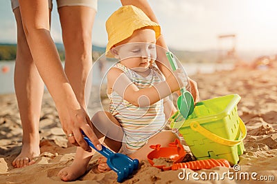 Mother with her baby on the beach Stock Photo