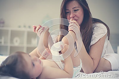 Mother with her baby at home. Mother changing diaper her little Stock Photo