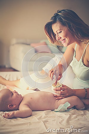 Mother and her baby. Time to change dippers. Stock Photo