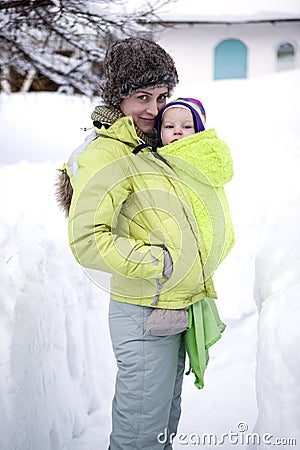 A mother and her baby walking in winter Stock Photo