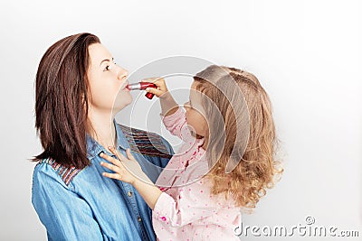 Mother and her child daughter girl with a lipstick. Portrait of Stock Photo