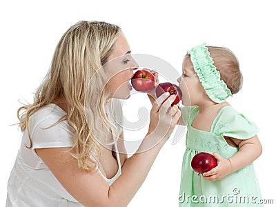 Mother and her child feed each other by red apples Stock Photo