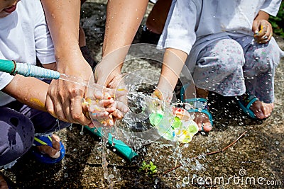 Mother and her child washing hands together after painted Stock Photo