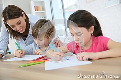 Mother with her children spending time together drawing Stock Photo