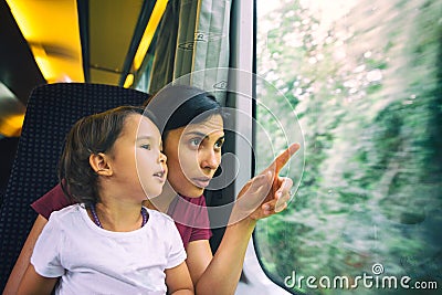 Mother and her daughter enjoing the train trip Stock Photo