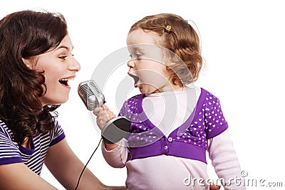 Mother and her daughter sing into microphone Stock Photo