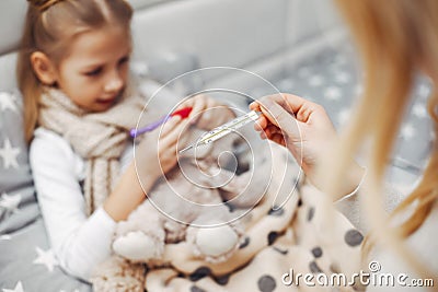 Mother with her illnes daughter in a bedroom Stock Photo