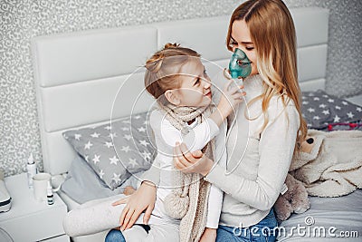 Mother with her illnes daughter in a bedroom Stock Photo