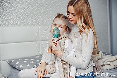 Mother with her illnes daughter in a bedroom Stock Photo