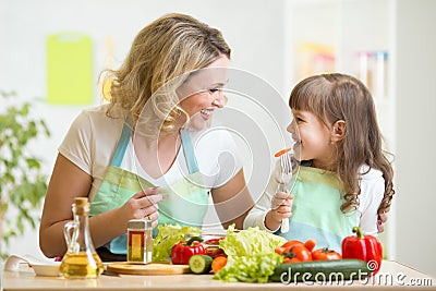 Mother and her kid preparing healthy food and Stock Photo