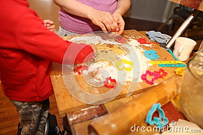 mother and her little baby making hands cookies at home in the kitchen Stock Photo