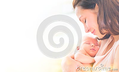 Mother and her newborn baby together. Happy mother and baby kissing and hugging. Maternity concept Stock Photo