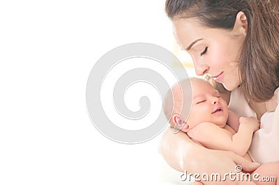 Mother and her Newborn Baby together. Love. Happy Mother and Baby kissing and hugging. High key soft image of Beautiful Family Stock Photo