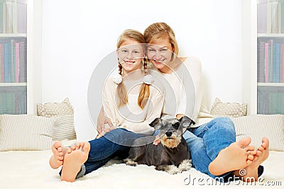 Mother with her 10 years old kid girl sitting home, Stock Photo