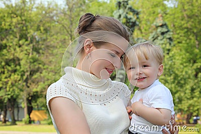 Mother hold baby on hands outdoor Stock Photo