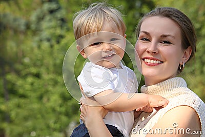 Mother hold baby on hands outdoor Stock Photo