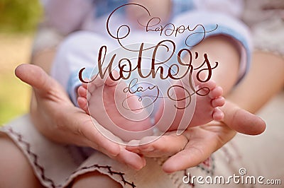 Mother hold the feet of her newborn son and Happy mothers day text. Calligraphy lettering hand draw Stock Photo