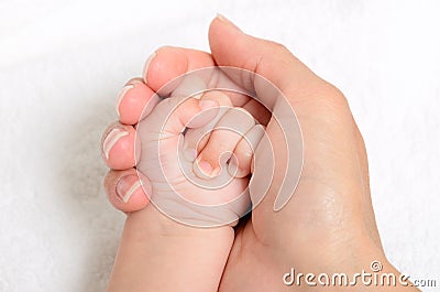 Mother holding a baby hand Stock Photo