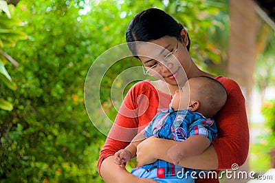 A mother holding her baby with love. Stock Photo