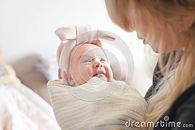 Mother holding of her newborn in hands. The baby on hands at mum. Loving mother hand holding cute sleeping newborn baby child Stock Photo