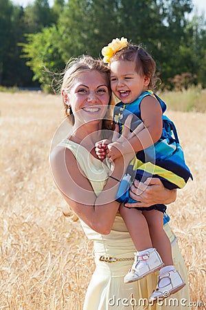Mother holds the little daughter on hands Stock Photo