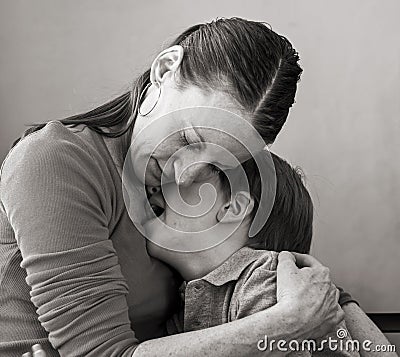 Mother hugs crying son Stock Photo