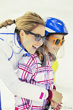 Mother hugs his son affectionately in the snow Stock Photo