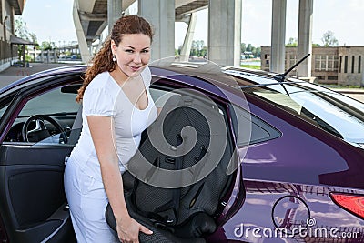 Mother installing child restraint seat in the car Stock Photo