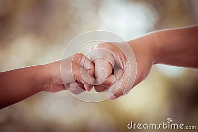 Mother and kid daughter are fist bumping Stock Photo