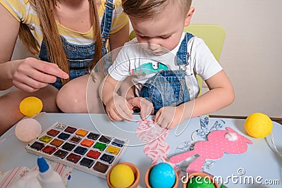 Mother with kid paint eggs Stock Photo