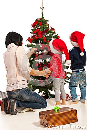 Mother with kids decorate tree Stock Photo