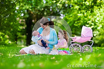 Mother and kids enjoying picnic outdoors Stock Photo