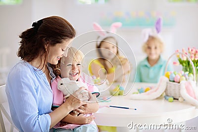 Mother and kids, family coloring Easter eggs Stock Photo