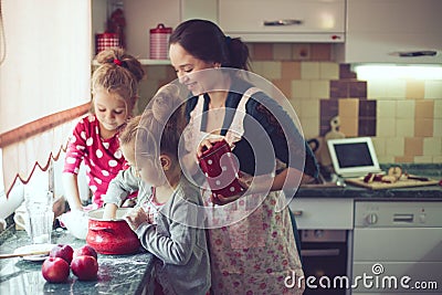 Mother with kids at the kitchen Stock Photo