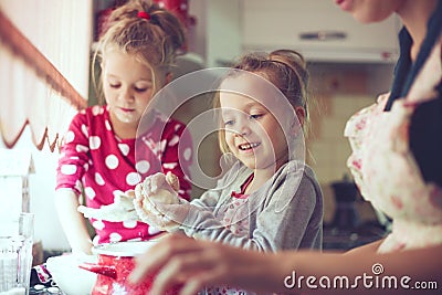 Mother with kids at the kitchen Stock Photo