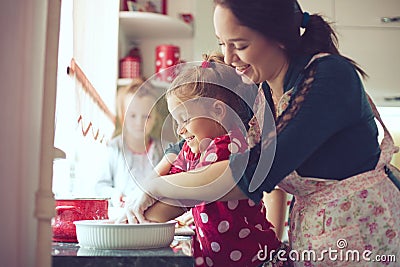 Mother with kids at the kitchen Stock Photo