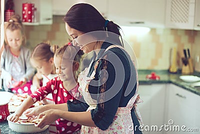 Mother with kids at the kitchen Stock Photo