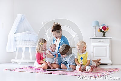 Mother and kids playing in bedroom Stock Photo