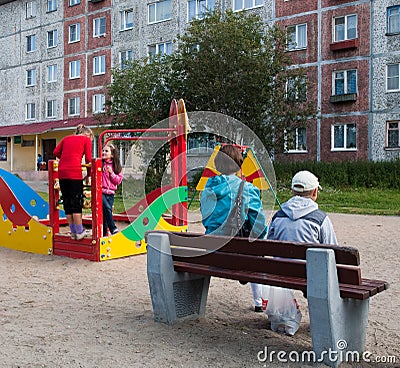 Mother and kids playing on the playground in the yard Editorial Stock Photo