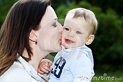 Mother kiss baby boy Stock Photo