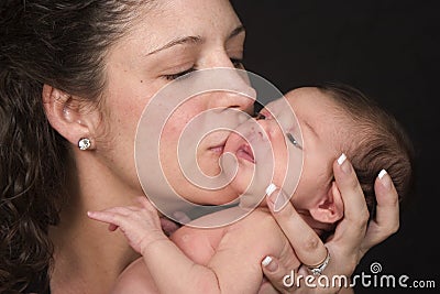 Mother kissing baby Stock Photo