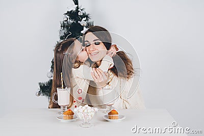 Mother and little daughter drink cocoa with marshmallows Stock Photo