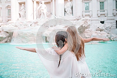 Mother and little girl at Trevi Fountain, Rome. Little girl making a wish to come back. Stock Photo