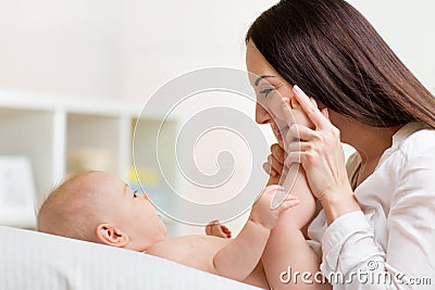 Mother looks with love at baby. Parenthood Stock Photo