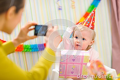 Mother making photos of babys first birthday Stock Photo