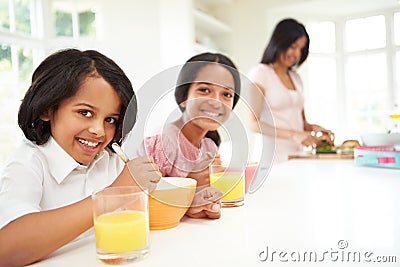 Mother Making School Packed Lunches For Children Stock Photo