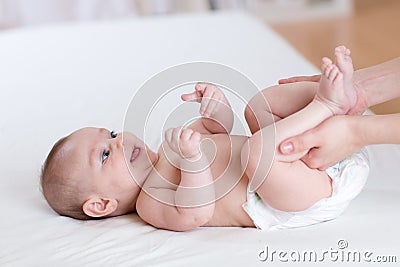 Mother massaging her little baby Stock Photo