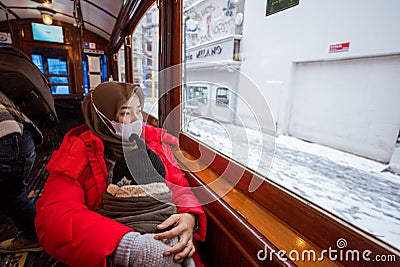 mother muslim sitting inside a tram with her son Stock Photo
