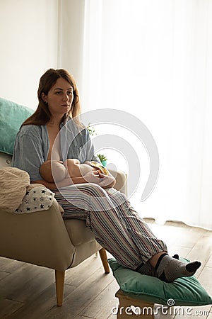 Mother with naked newborn on lighted white background Stock Photo