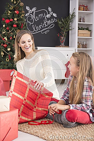 Mother packing gifts with daughter Stock Photo